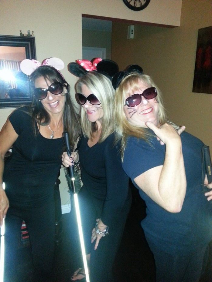 PHoto of d myTwo girlfriends, Ursula and Robin, and myself dressed up in sunglasses, mouse ears, Whiskers, and Laughing holding white canes.